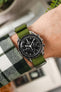 Omega Speedmaster fitted Green Nylon Watch Strap on wrist with check shirt